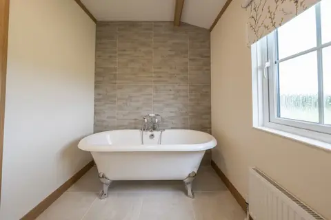 Bathroom with roll‑top bath