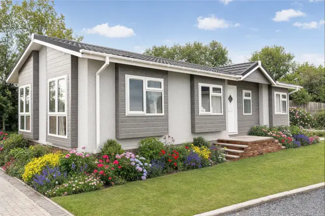 Hardwick park home exterior with grey cladding and render