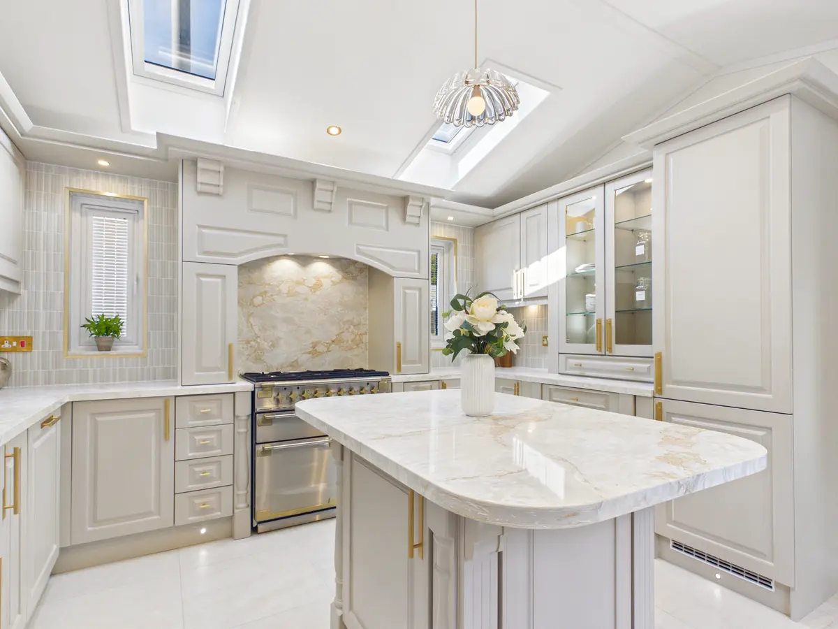 Diamond show home kitchen with roof windows, slender windows framing the cooker and a pendant light over the island
