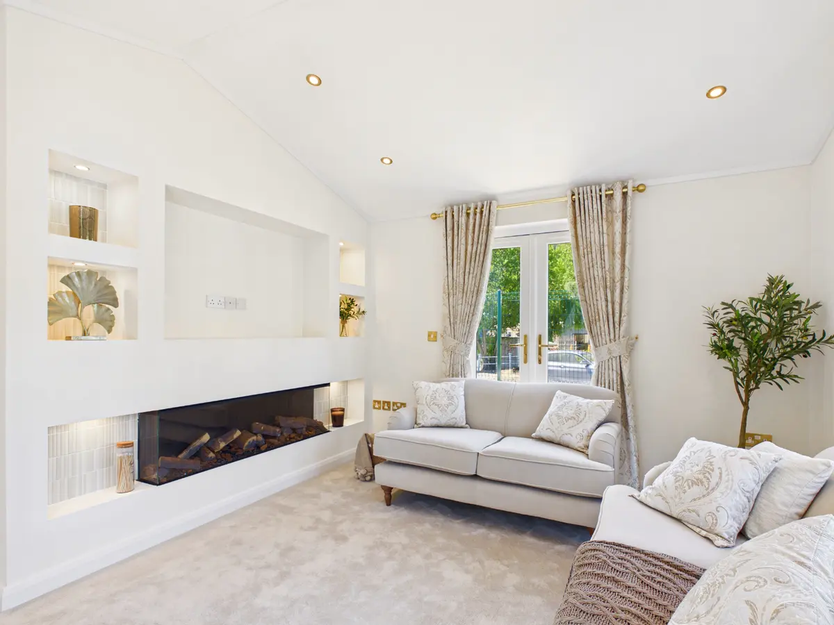 Diamond show home lounge with an illuminated media wall, display shelving and integrated widescreen fire