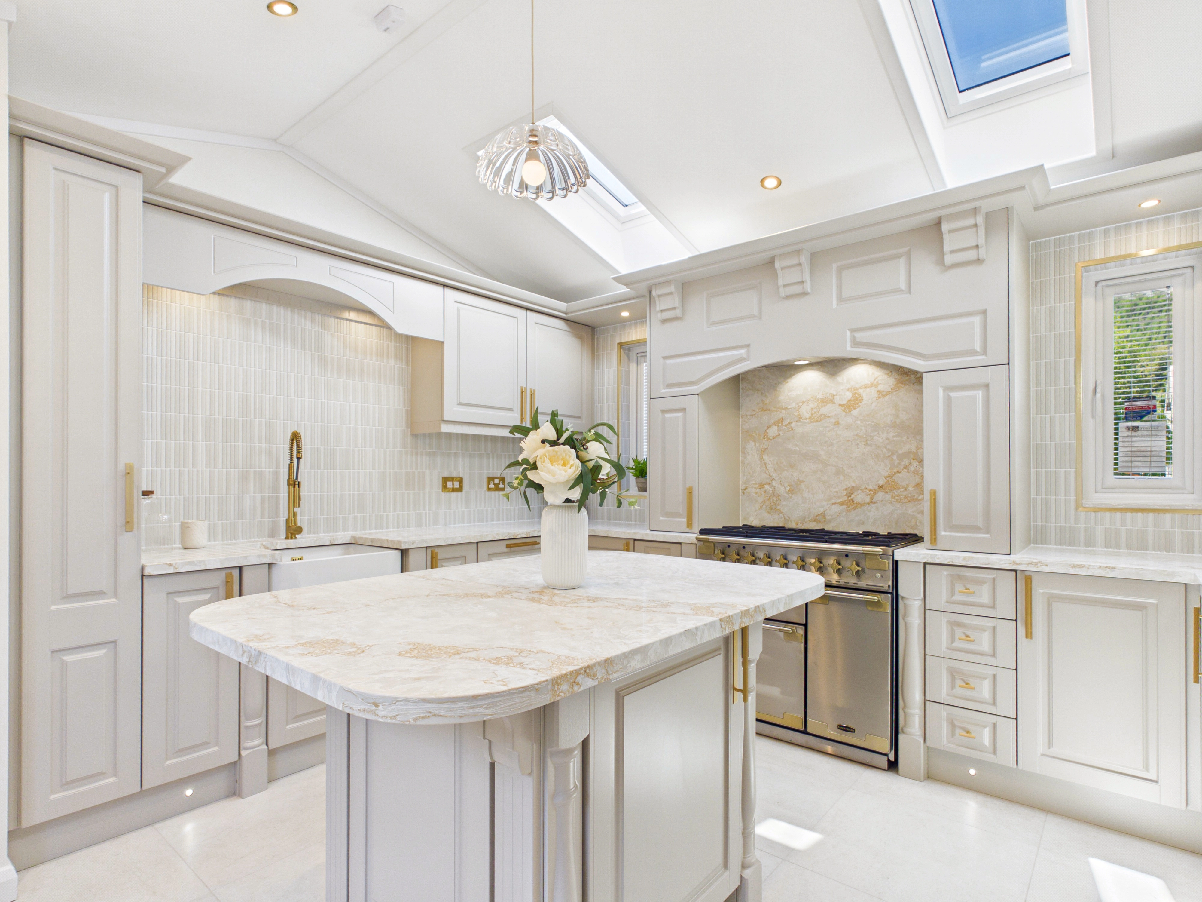 Diamond show home kitchen with the range cooker on the back wall and Belfast sink beneath an arched pelmet